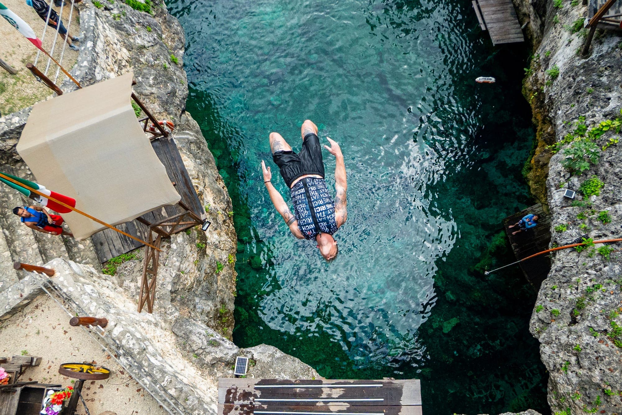 A jumper entering the water, seen from the platform above